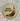 Round magnet with image of a bruised banana and the phrase "been better!"