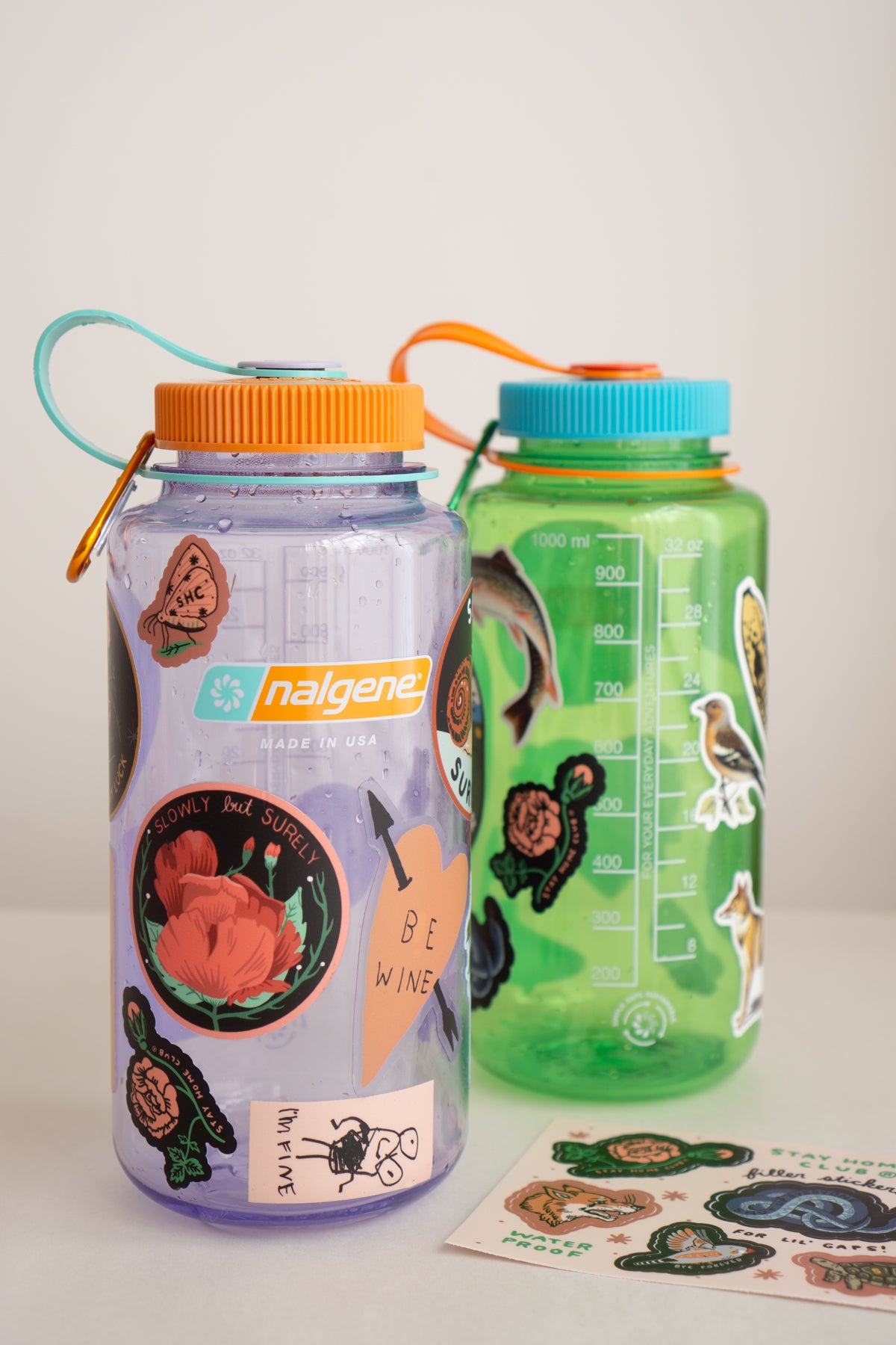 amethyst and pear Nalgene water bottles with stickers