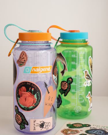amethyst and pear Nalgene water bottles with stickers