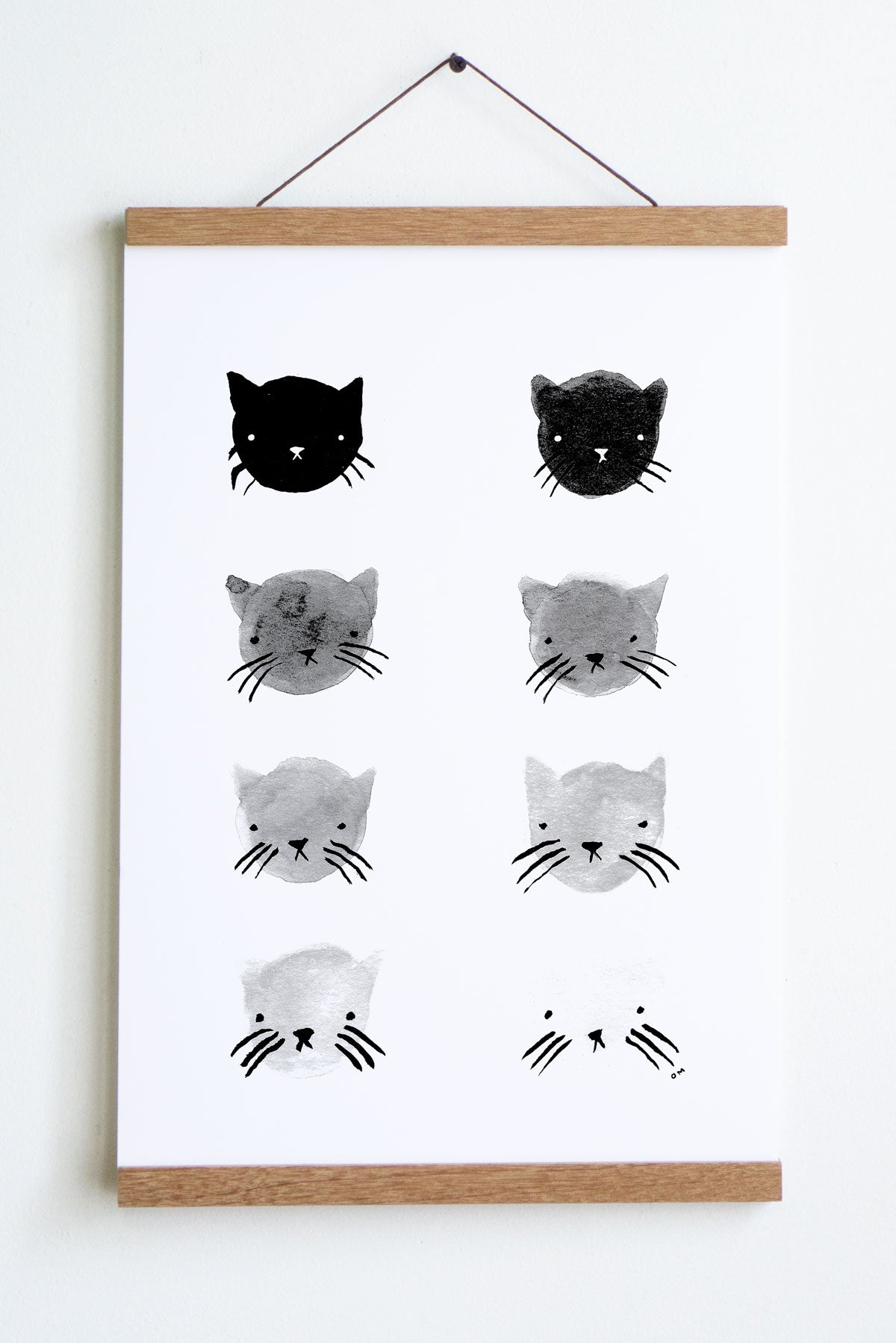 wooden hanger holding white paper with 8 cats in black to white gradiant