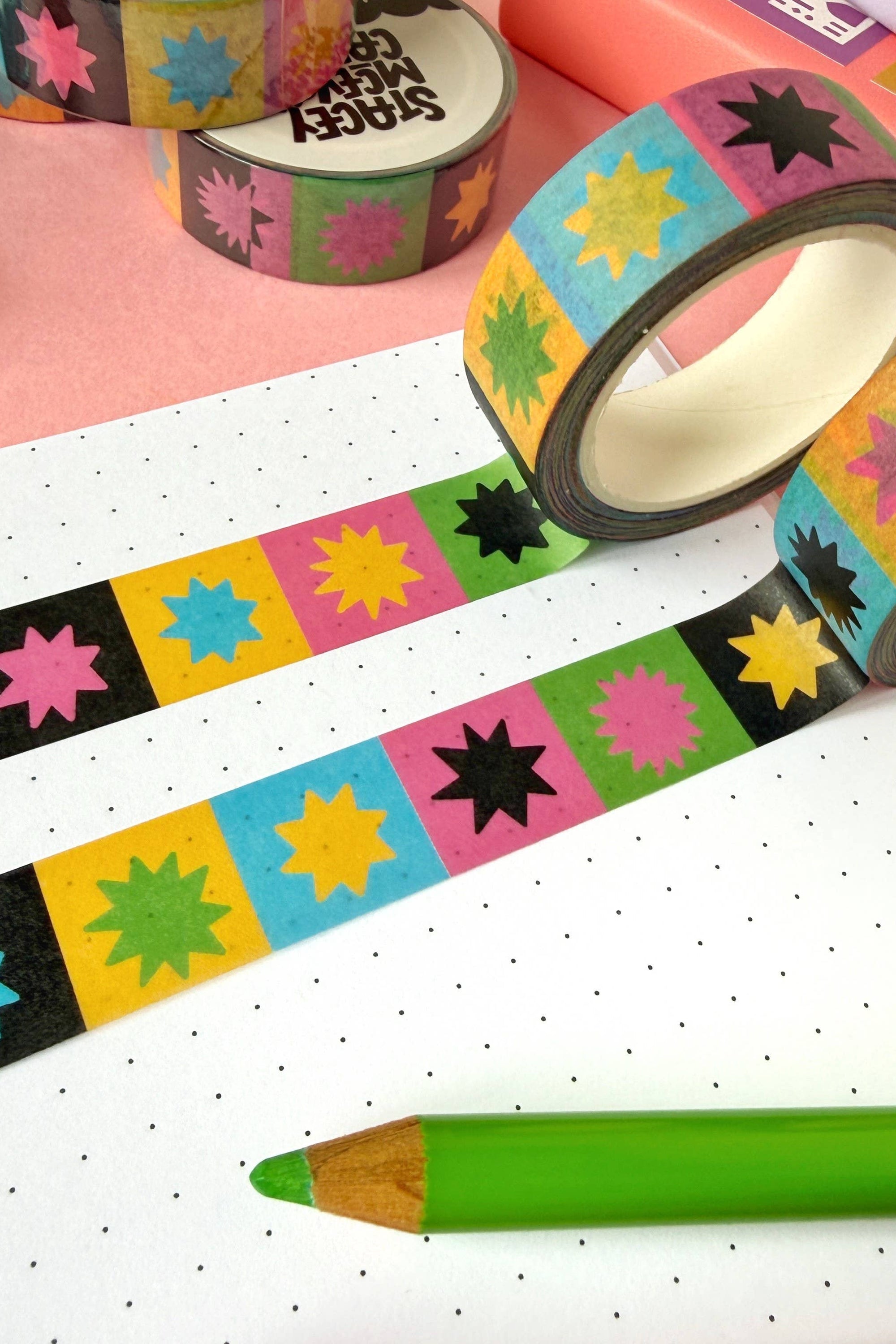 Colorful washi tape with colourful star patterns on a pink and white background