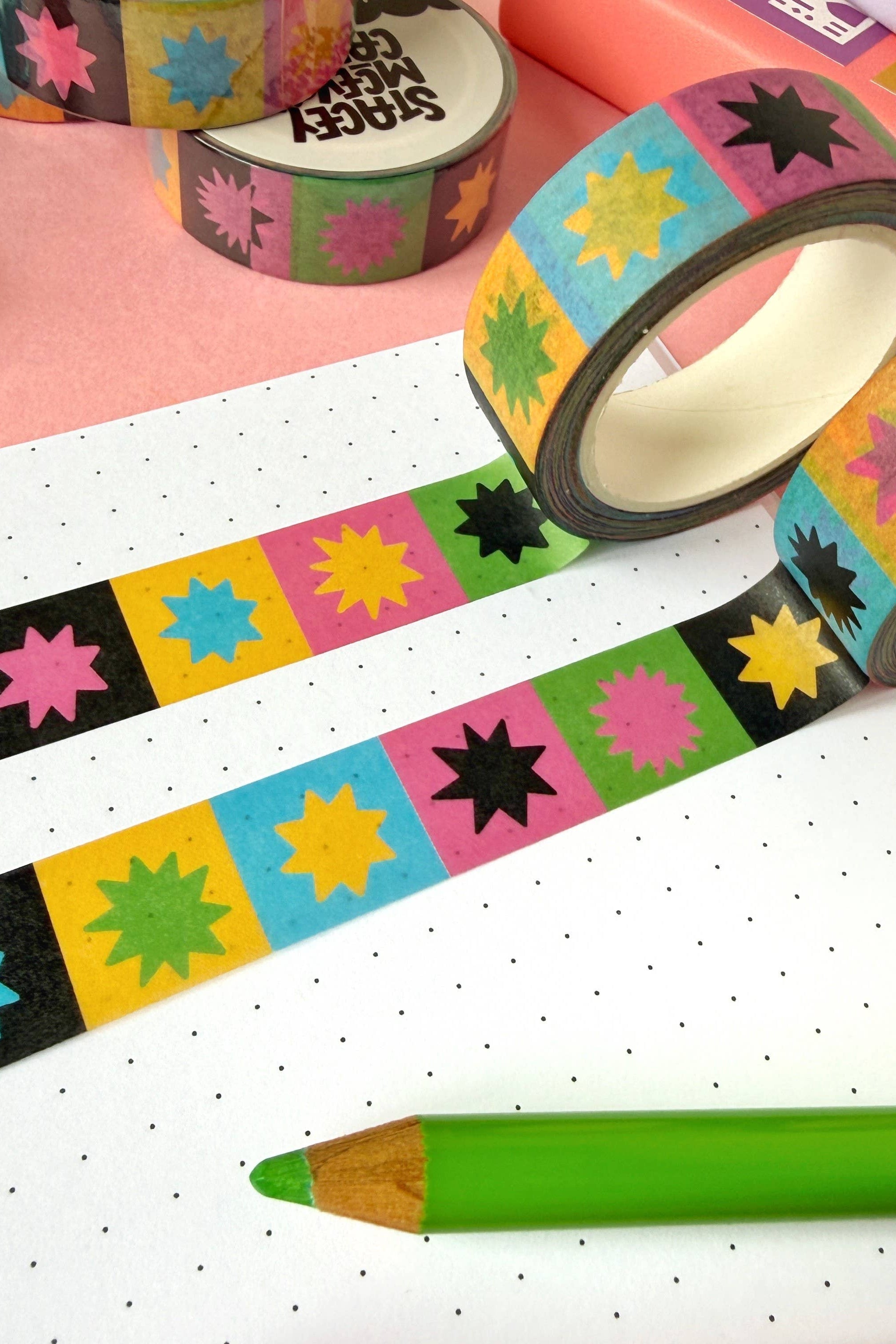 Colorful washi tape with colourful star patterns on a pink and white background