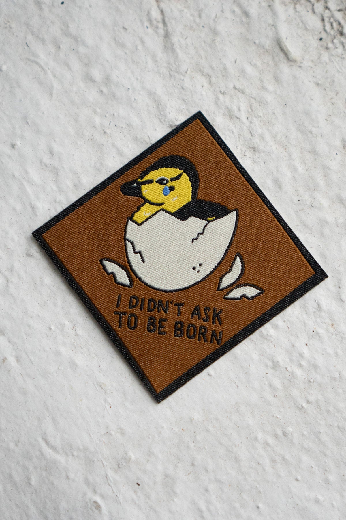 Patch featuring a duckling hatching out of an egg and the phrase "I didn't ask to be born"