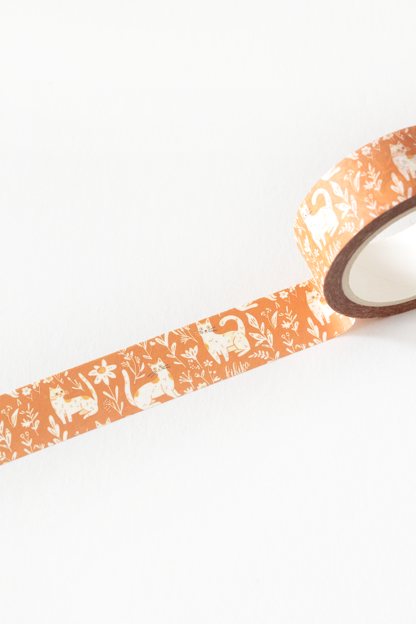 Decorative tape with a cats and floral pattern on a white background