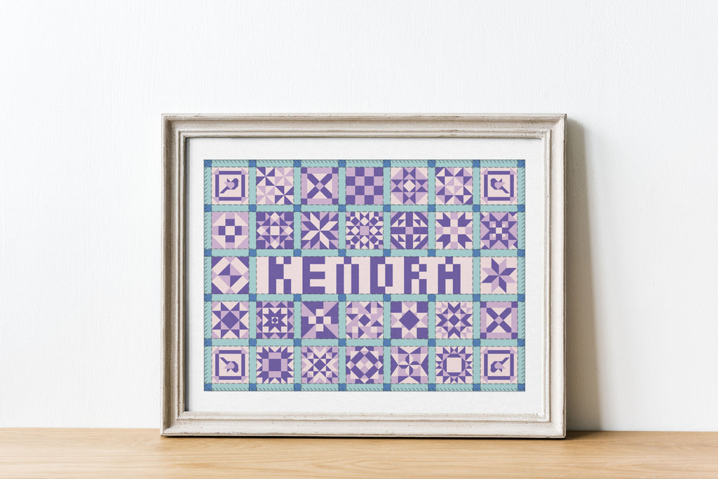 a framed illustration of a patchwork quilt with the name Kendra written in the center