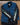 Black long-sleeved tee with lily of the valley flowers prited down the sleeves layered under a denim vest