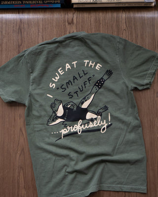 Deep green t-shirt featuring an anxious frog print, seen from the back