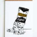 black line drawing of sitting cat with black and white chip bag with text ruffles and yellow chips over its head 