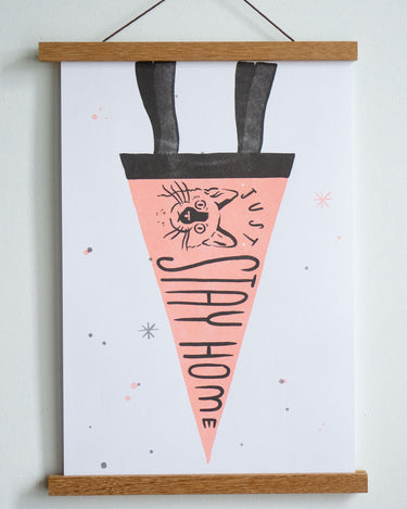 drawing of pink pennant with black trim with a drawing of cat and text just stay home in black font