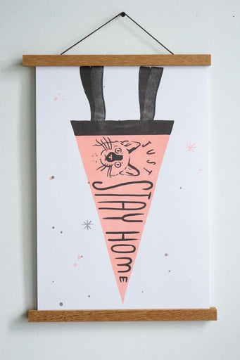 drawing of pink pennant with black trim with a drawing of cat and text just stay home in black font
