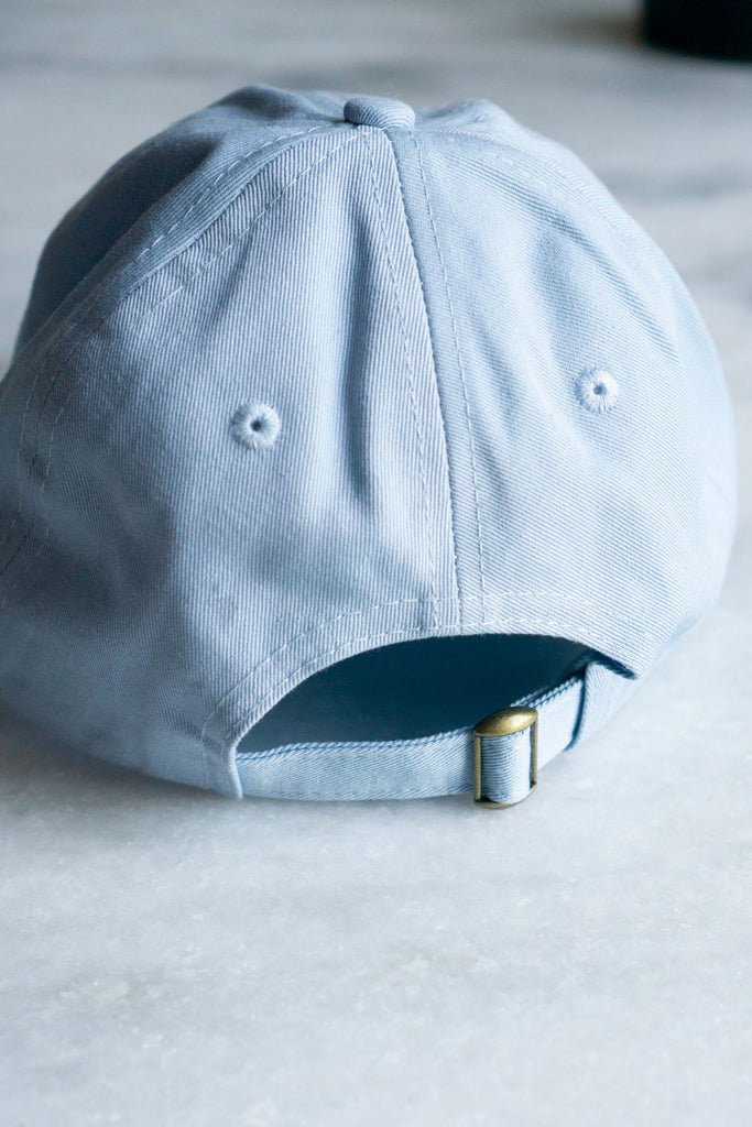 back of pale blue baseball hat with brass sliding clasp 